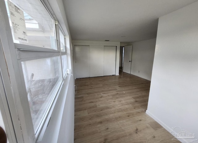 unfurnished room with light wood-style flooring