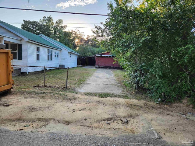 exterior space with cooling unit and fence