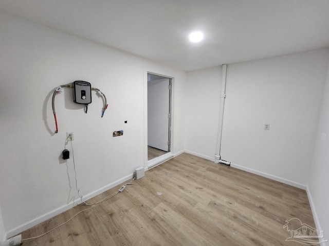 washroom with light wood-style flooring and baseboards