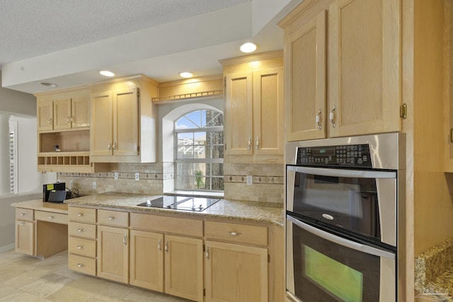 kitchen with double oven, backsplash, black electric stovetop, and light brown cabinets