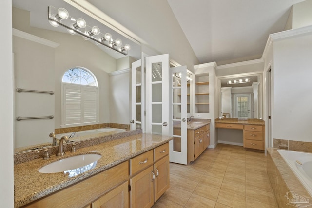 bathroom with vanity, tile patterned flooring, vaulted ceiling, and tiled bath