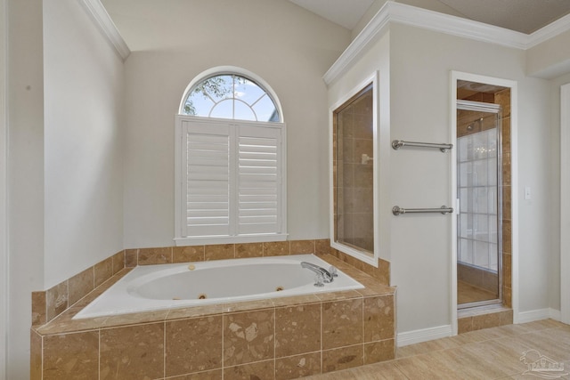 bathroom with ornamental molding and shower with separate bathtub