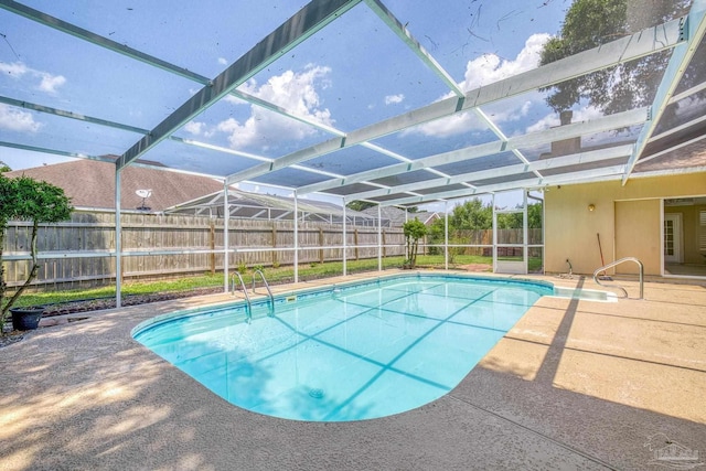 view of swimming pool featuring a patio area and glass enclosure