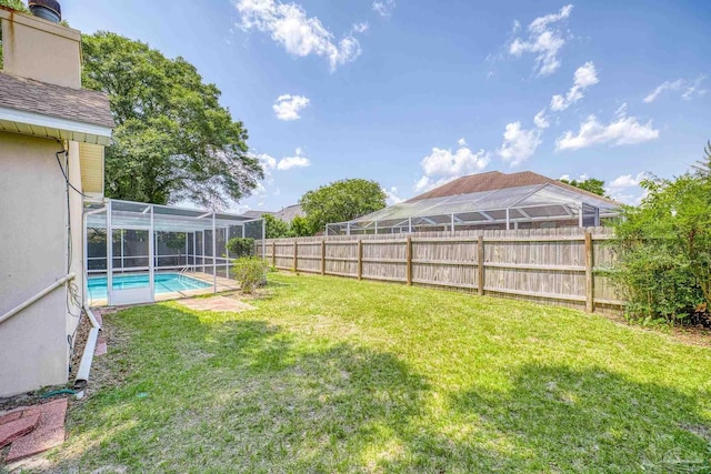 view of yard featuring a fenced in pool and a lanai