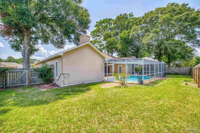 back of property with a fenced in pool, a yard, and glass enclosure