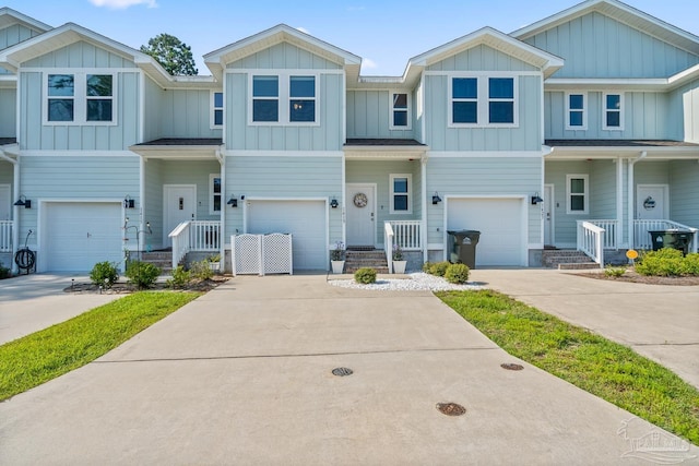 view of front of property with board and batten siding, a garage, and concrete driveway