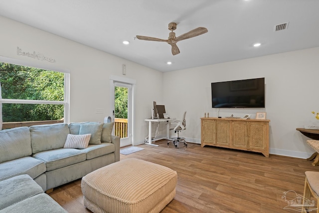 living area featuring a ceiling fan, recessed lighting, visible vents, and light wood finished floors