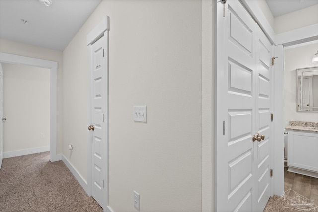 corridor with carpet floors and baseboards