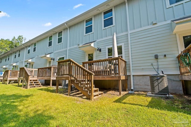 back of property featuring central air condition unit, a yard, board and batten siding, and a wooden deck