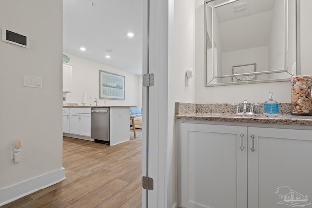 full bath featuring baseboards, wood finished floors, vanity, and recessed lighting