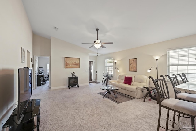 5183 Teresa Dr, Milton, FL 32583 - carpeted living room featuring a ceiling fan, lofted ceiling, baseboards, and a wood stove