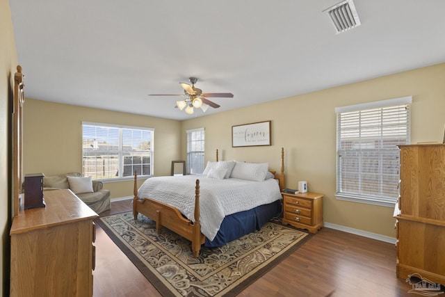 bedroom with ceiling fan and dark wood-type flooring