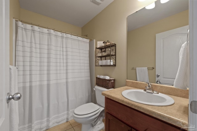 bathroom featuring toilet, vanity, and tile patterned flooring