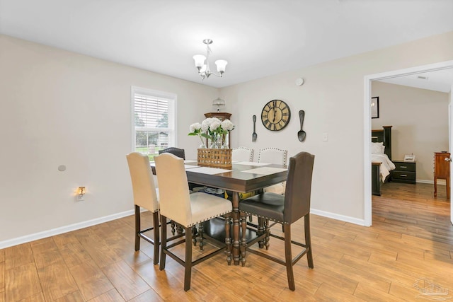 106 W Meadow Dr, Atmore, AL 36502 - dining area featuring a chandelier, light wood finished floors, and baseboards