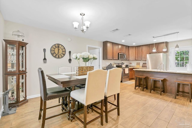 106 W Meadow Dr, Atmore, AL 36502 - dining space featuring light wood-style floors, a chandelier, and recessed lighting