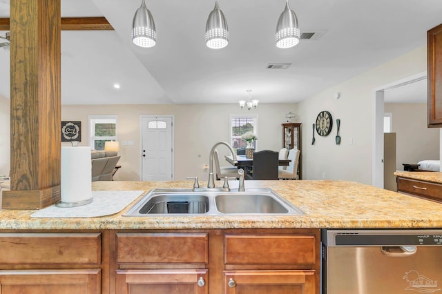 106 W Meadow Dr, Atmore, AL 36502 - kitchen featuring stainless steel dishwasher, a sink, open floor plan, brown cabinetry, and a chandelier