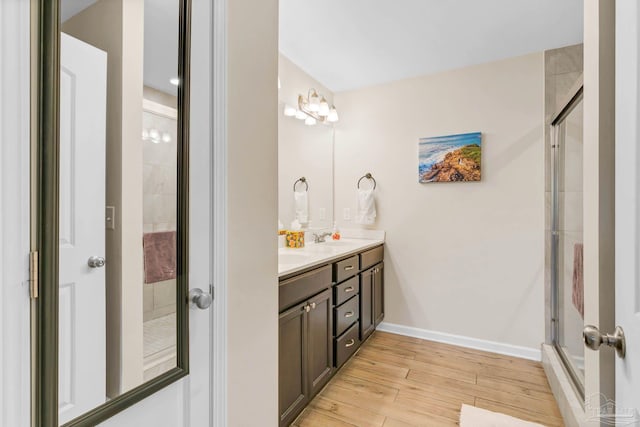 106 W Meadow Dr, Atmore, AL 36502 - full bath with wood finished floors, double vanity, an enclosed shower, and baseboards