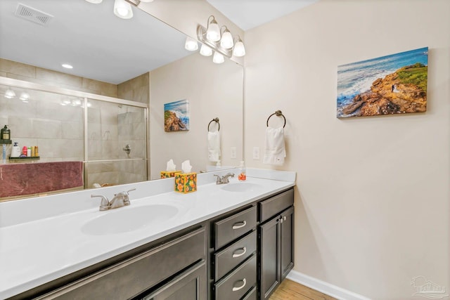 106 W Meadow Dr, Atmore, AL 36502 - full bath with double vanity, a stall shower, baseboards, and wood finished floors