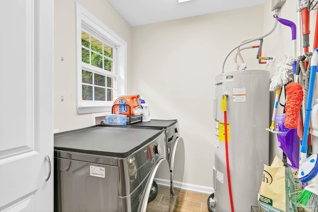 106 W Meadow Dr, Atmore, AL 36502 - laundry area featuring water heater, separate washer and dryer, baseboards, and wood finished floors