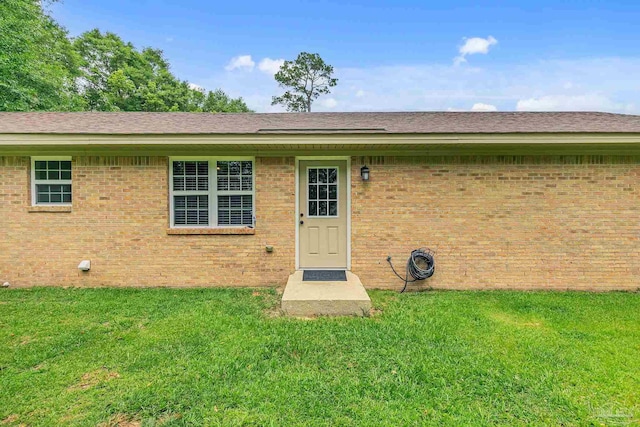 106 W Meadow Dr, Atmore, AL 36502 - property entrance featuring a yard and brick siding