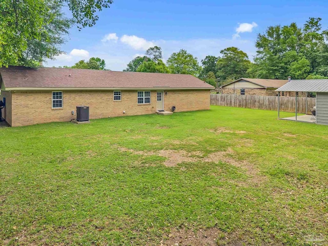 106 W Meadow Dr, Atmore, AL 36502 - back of house with central AC, a patio area, and brick siding