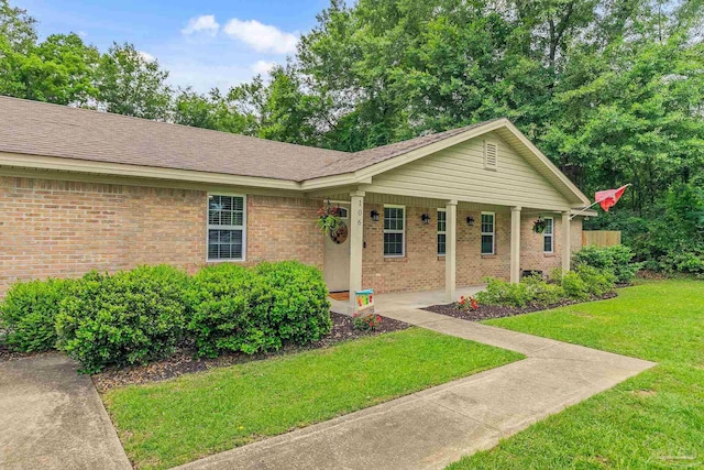 106 W Meadow Dr, Atmore, AL 36502 - ranch-style home featuring a front yard, brick siding, and covered porch