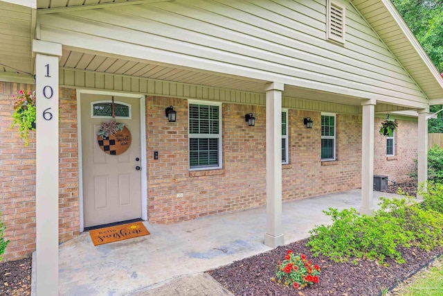 106 W Meadow Dr, Atmore, AL 36502 - property entrance featuring a porch and brick siding