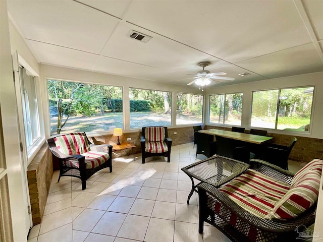 sunroom / solarium featuring ceiling fan