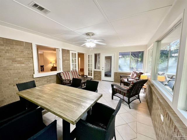 sunroom featuring ceiling fan