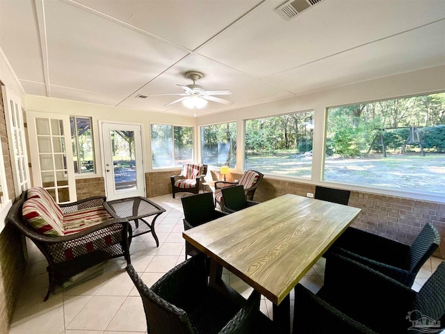 sunroom / solarium featuring ceiling fan