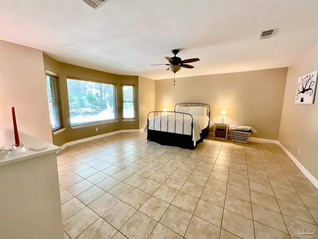 tiled bedroom featuring ceiling fan