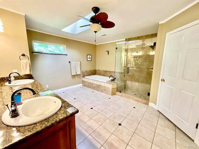 bathroom featuring a skylight, tile patterned flooring, crown molding, vanity, and independent shower and bath