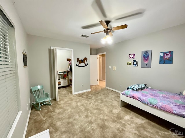 bedroom with carpet, a spacious closet, and ceiling fan