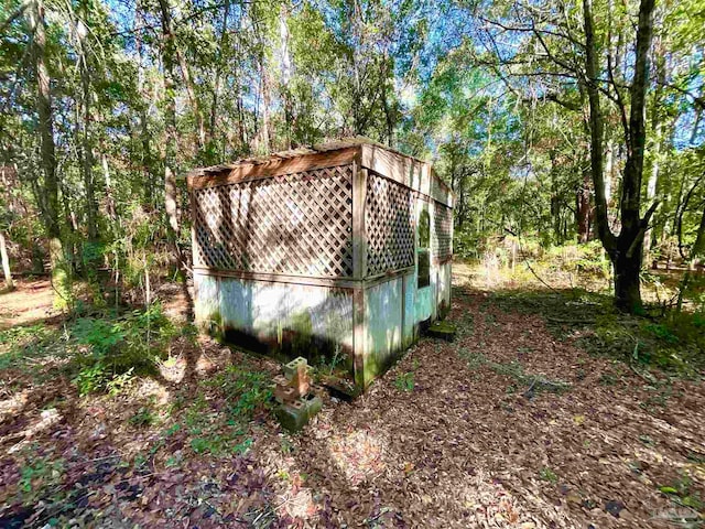 view of property exterior with an outbuilding