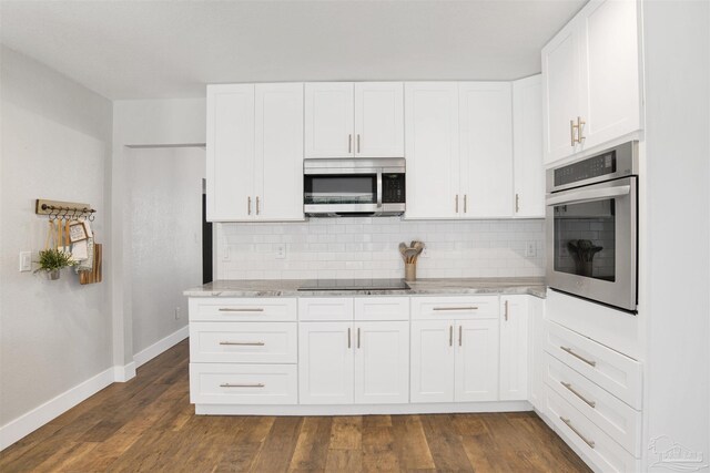 9852 Hillview Dr, Pensacola, FL 32514 - kitchen with stainless steel appliances, baseboards, decorative backsplash, white cabinetry, and light stone countertops