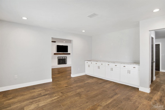 9852 Hillview Dr, Pensacola, FL 32514 - spare room with dark wood finished floors, a fireplace, baseboards, and recessed lighting