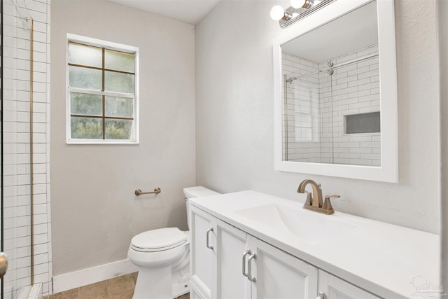 9852 Hillview Dr, Pensacola, FL 32514 - bathroom with vanity, toilet, baseboards, a tile shower, and tile patterned floors
