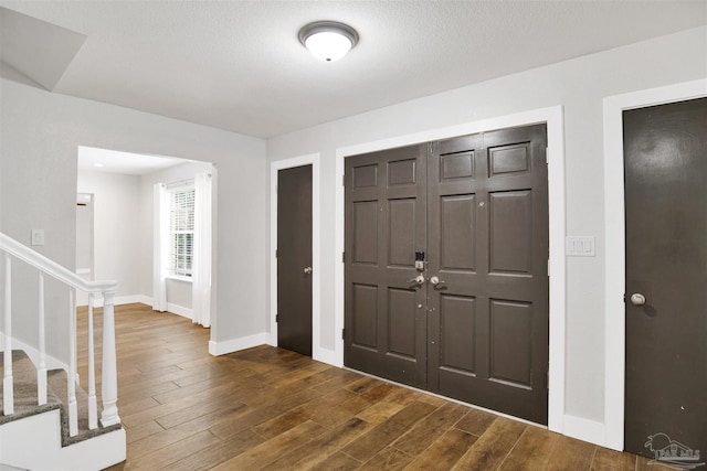 9852 Hillview Dr, Pensacola, FL 32514 - foyer entrance with baseboards, stairway, and dark wood-style floors