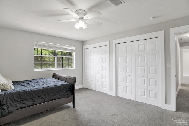 9852 Hillview Dr, Pensacola, FL 32514 - bedroom featuring multiple closets, carpet flooring, a ceiling fan, and baseboards