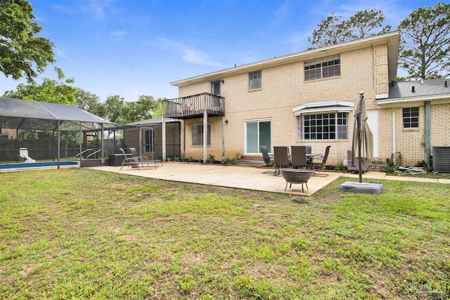 9852 Hillview Dr, Pensacola, FL 32514 - rear view of house featuring a balcony, entry steps, brick siding, a patio, and a lawn