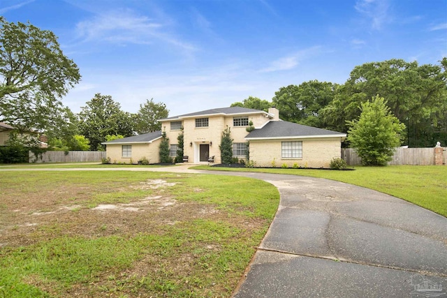 9852 Hillview Dr, Pensacola, FL 32514 - traditional-style home featuring curved driveway, a chimney, and brick siding