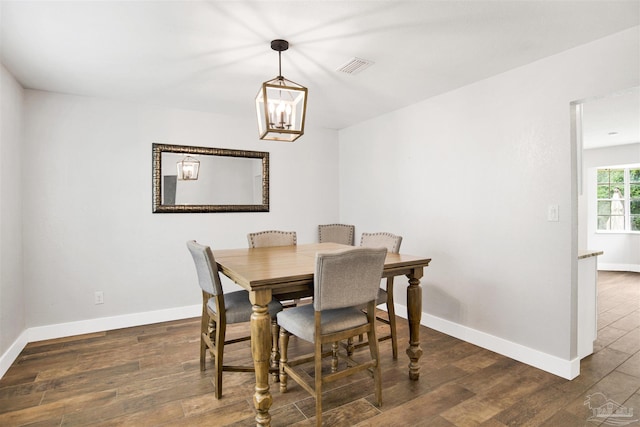 9852 Hillview Dr, Pensacola, FL 32514 - dining room featuring wood finished floors, baseboards, and a chandelier