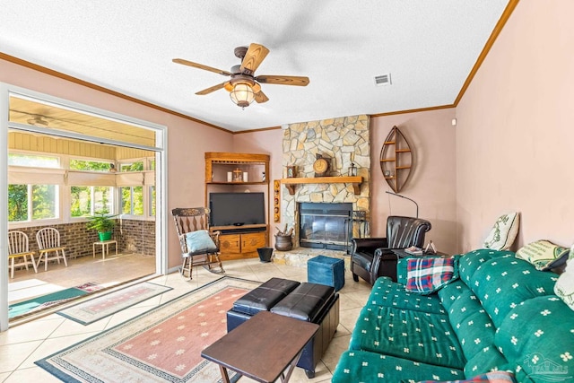 living area featuring tile patterned floors, a textured ceiling, crown molding, visible vents, and ceiling fan