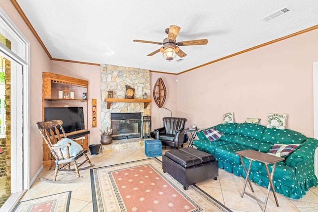 tiled living area featuring a ceiling fan, a textured ceiling, ornamental molding, and visible vents