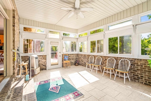 sunroom with a ceiling fan and a healthy amount of sunlight