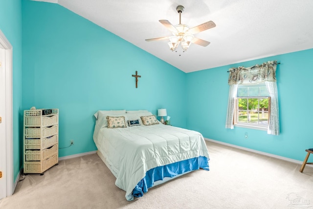 bedroom with carpet floors, baseboards, a ceiling fan, and lofted ceiling