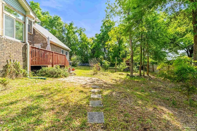 view of yard featuring a deck and fence