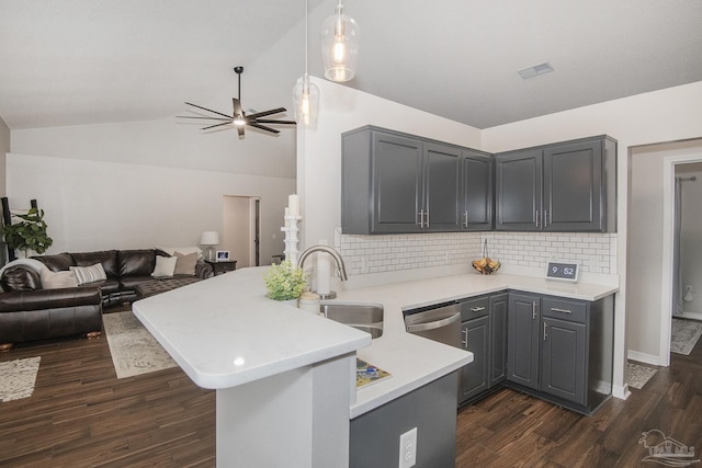 kitchen featuring sink, gray cabinetry, vaulted ceiling, stainless steel dishwasher, and kitchen peninsula