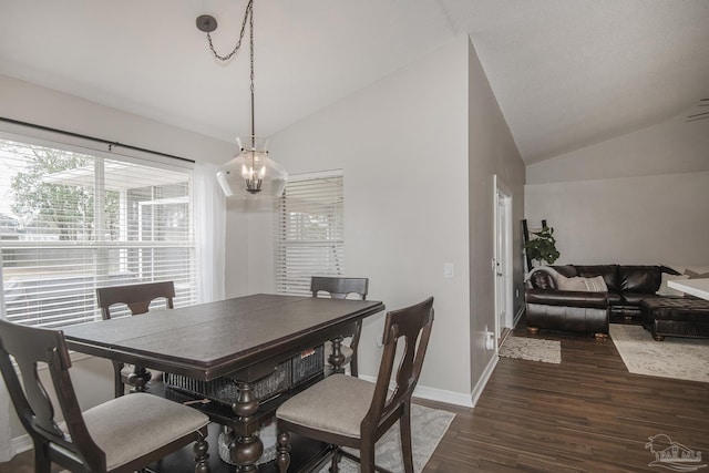 dining space featuring baseboards, vaulted ceiling, dark wood-style flooring, and a chandelier