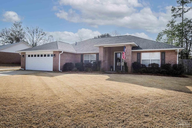 ranch-style home with a garage and a front lawn